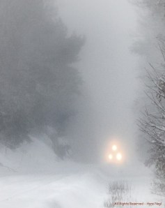 Franklin Line T Commuter Train becoming visible through the heavy blizzard snow