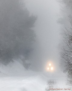 Franklin Line T Commuter Train becoming visible through the heavy blizzard snow