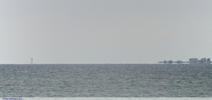 Just beyond the Horizon this light tower and houses can be seen. - Onset Massachusetts - ©HansNagl.com